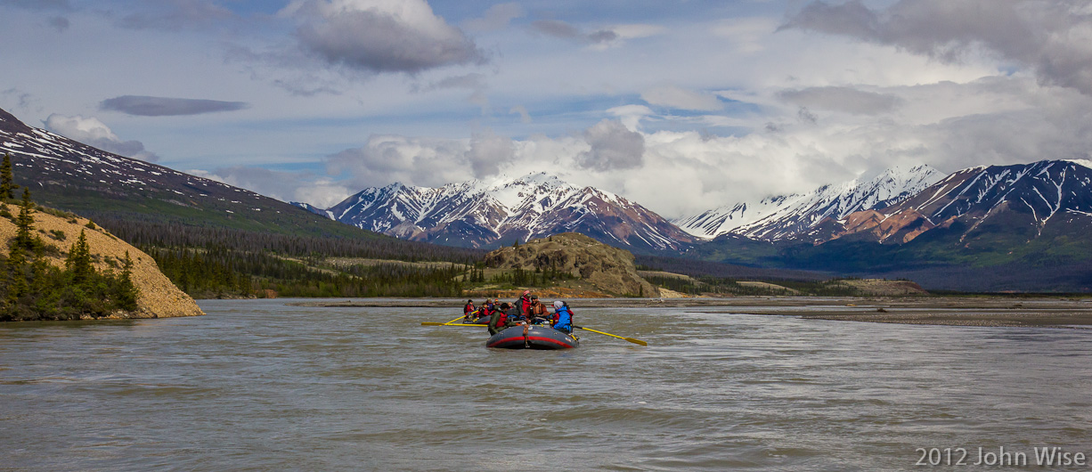 Looking back up river at two rafts following our lead on the Alsek River in the Yukon, Canada